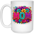 A white ceramic mug featuring a vibrant graphic design with the word 'MOM' in glittery pink and teal letters, surrounded by a colorful floral arrangement of pink, purple, blue, and yellow flowers.
