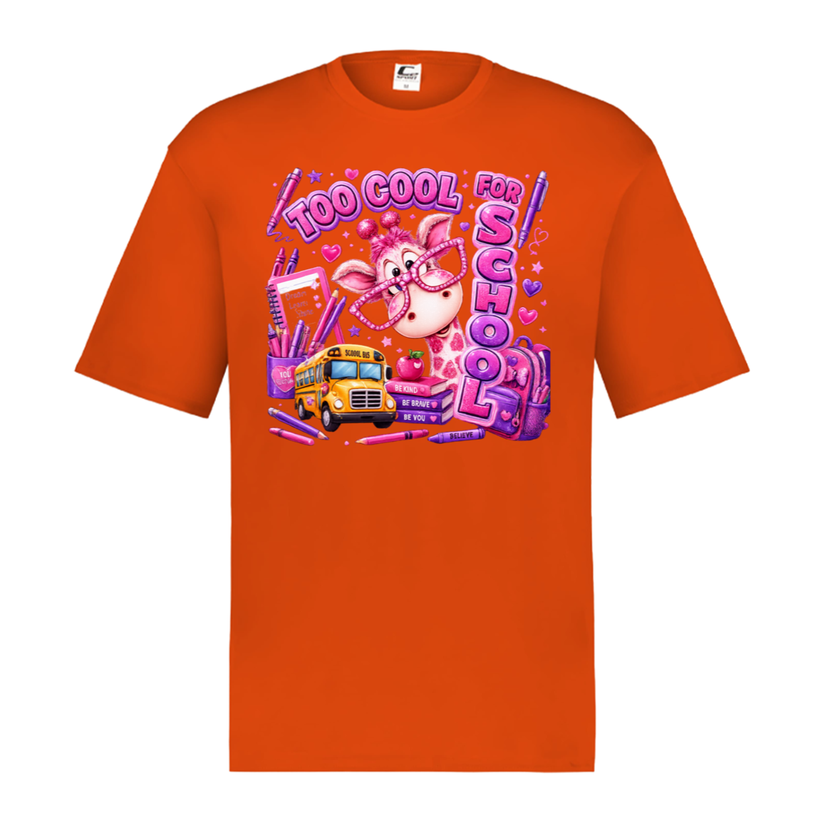 An orange short-sleeve crewneck t-shirt featuring a colorful graphic print on the front. The graphic depicts a cartoon pig wearing glasses next to a yellow school bus, surrounded by pink and purple text that reads 'TOO COOL FOR SCHOOL' and school supplies.
