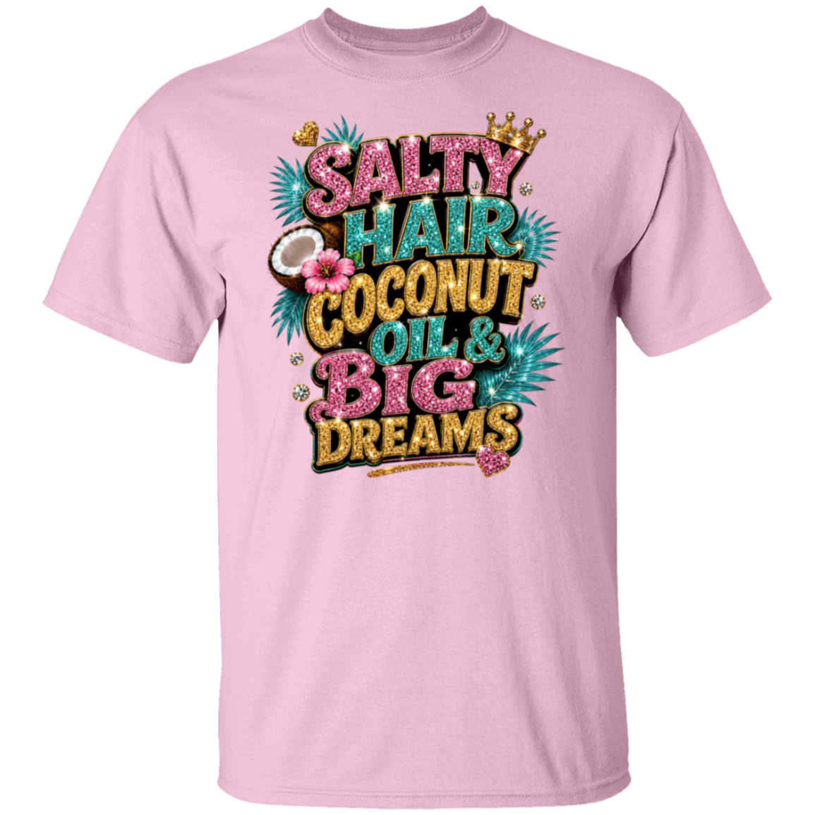 A light pink short-sleeve crewneck t-shirt featuring a colorful graphic print on the front with the text 'SALTY HAIR COCONUT OIL & BIG DREAMS' in glittery pink, teal, and gold lettering, decorated with palm leaves, a coconut, and a small crown.