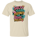 A natural crewneck t-shirt featuring a colorful graphic print on the front with the text 'SALTY HAIR COCONUT OIL & BIG DREAMS' in pink, teal, and gold glitter-style lettering, decorated with a crown, palm leaves, and a coconut.