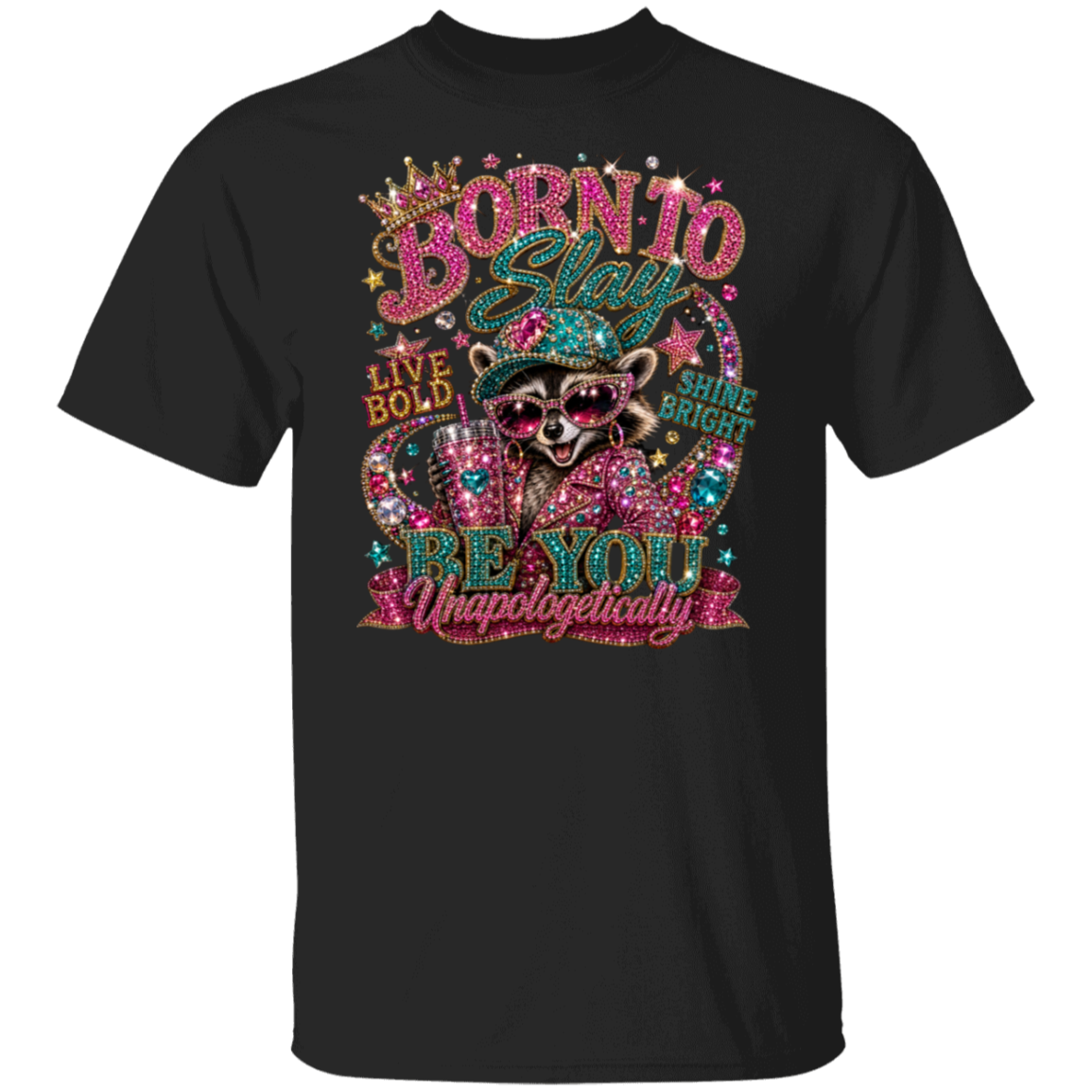 A black short-sleeve crewneck t-shirt featuring a colorful, glittery graphic of a raccoon wearing sunglasses and a top hat, surrounded by rhinestone-style text that reads 'BORN TO GLITTER' and 'LIVE BOLD BE YOU Unapologetically'.