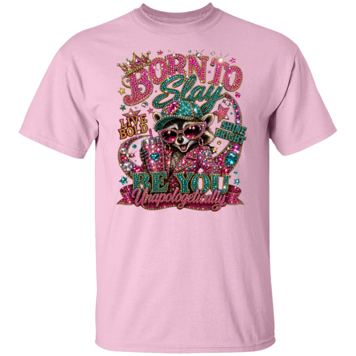 A light pink crewneck t-shirt featuring a large, glittery graphic of a raccoon wearing sunglasses and a hat, surrounded by decorative text and sparkles.