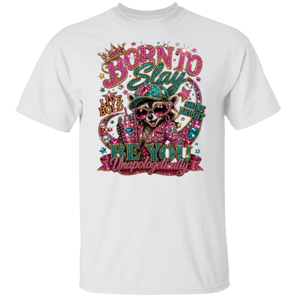 A white short-sleeve crewneck t-shirt featuring a colorful, rhinestone-embellished graphic of a raccoon wearing sunglasses and a hat, with the text 'BORN TO Stay BE YOU Unapologetically'.