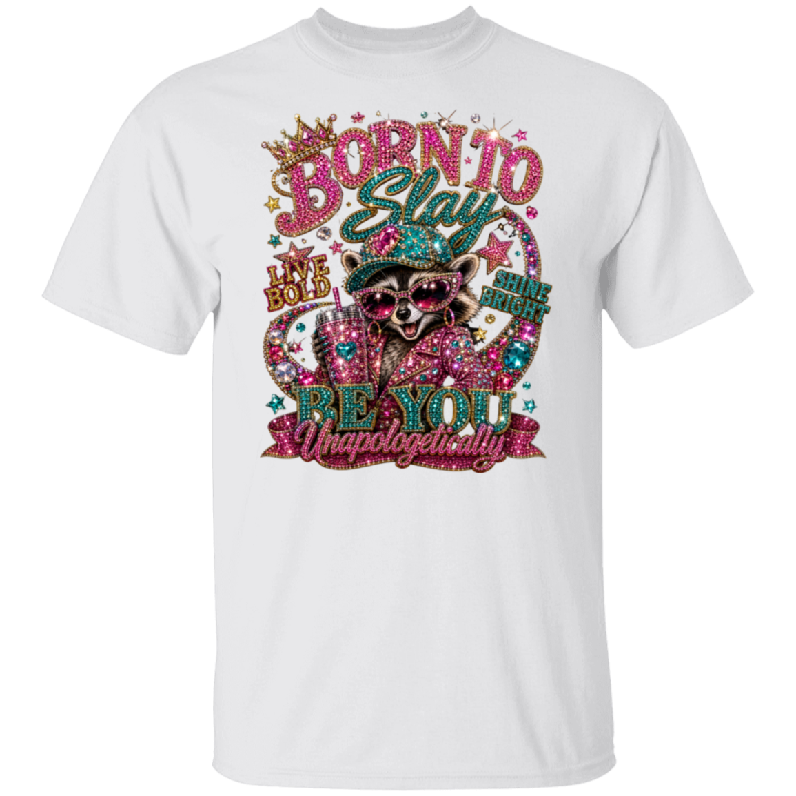 A white short-sleeve crewneck t-shirt featuring a colorful, rhinestone-embellished graphic of a raccoon wearing sunglasses and a hat, with the text 'BORN TO Stay BE YOU Unapologetically'.