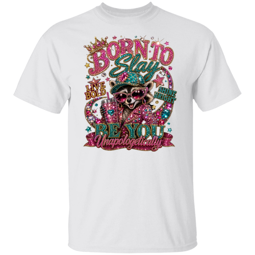 A white short-sleeve crewneck t-shirt featuring a colorful, rhinestone-embellished graphic of a raccoon wearing sunglasses and a hat, with the text 'BORN TO Stay BE YOU Unapologetically'.