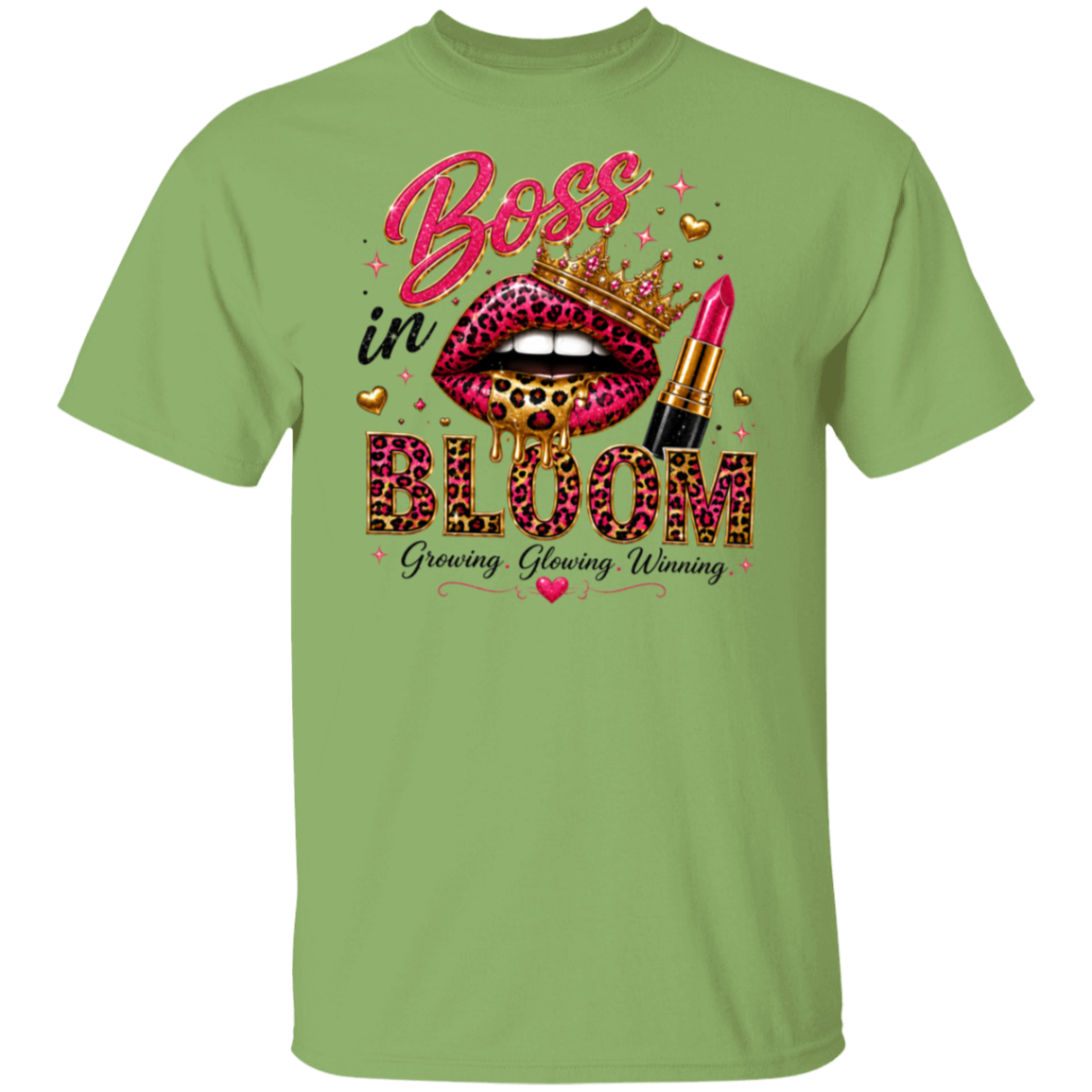 A kiwi color crewneck t-shirt featuring a colorful graphic print on the front. The graphic displays a pair of leopard-print lips wearing a gold crown, a pink lipstick tube, and the words 'Boss in BLOOM' in pink and black, with 'Growing, Glowing, Winning' written below.