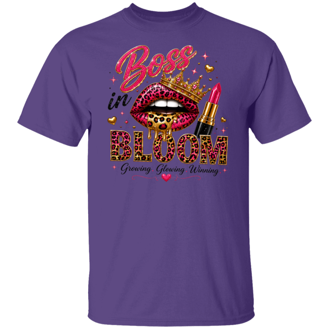 A purple short-sleeve crewneck t-shirt featuring a colorful graphic print on the front. The graphic displays a pair of leopard-print lips wearing a gold crown, a red lipstick tube, and the words 'Boss in BLOOM' with 'Growing, Glowing, Winning' underneath.