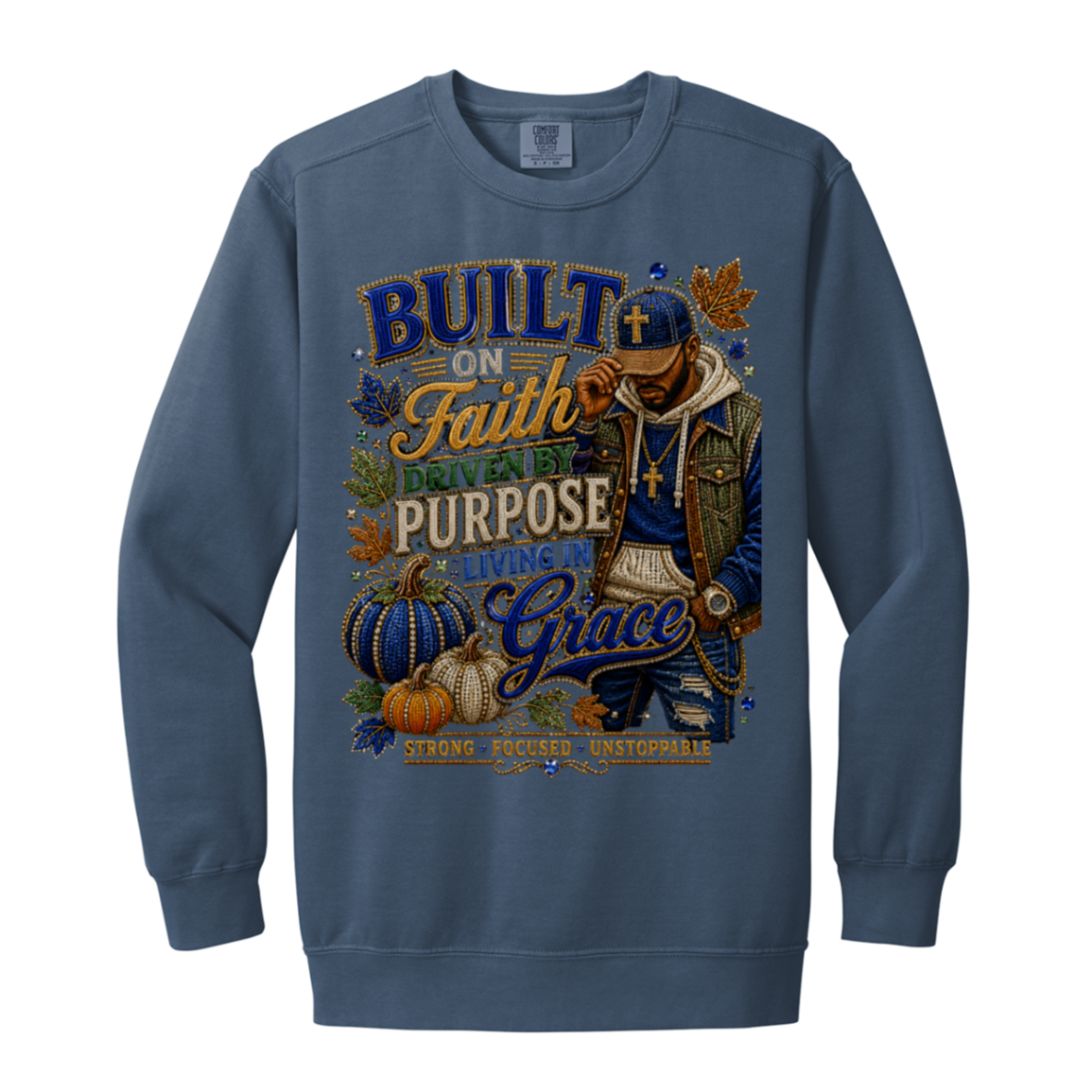 A blue jean color crewneck sweatshirt featuring a large, detailed graphic print on the front. The graphic depicts a man wearing a cap and gold chain next to pumpkins and autumn leaves, surrounded by text that reads 'BUILT ON Faith, LIVING BY PURPOSE, GIVING Grace'
