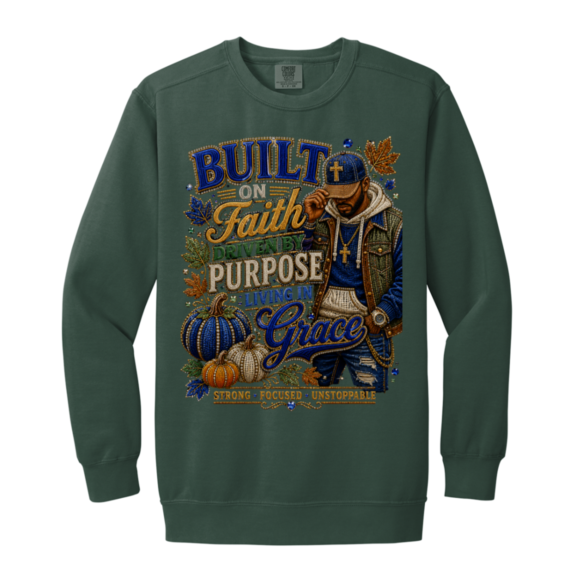 A blue spruce color crewneck sweatshirt featuring a large, detailed graphic print on the front. The graphic depicts a man in a blue cap and jacket with gold chains, surrounded by pumpkins, autumn leaves, and text that reads 'BUILT ON Faith, DESIGNED for PURPOSE, LIVING in Grace'.