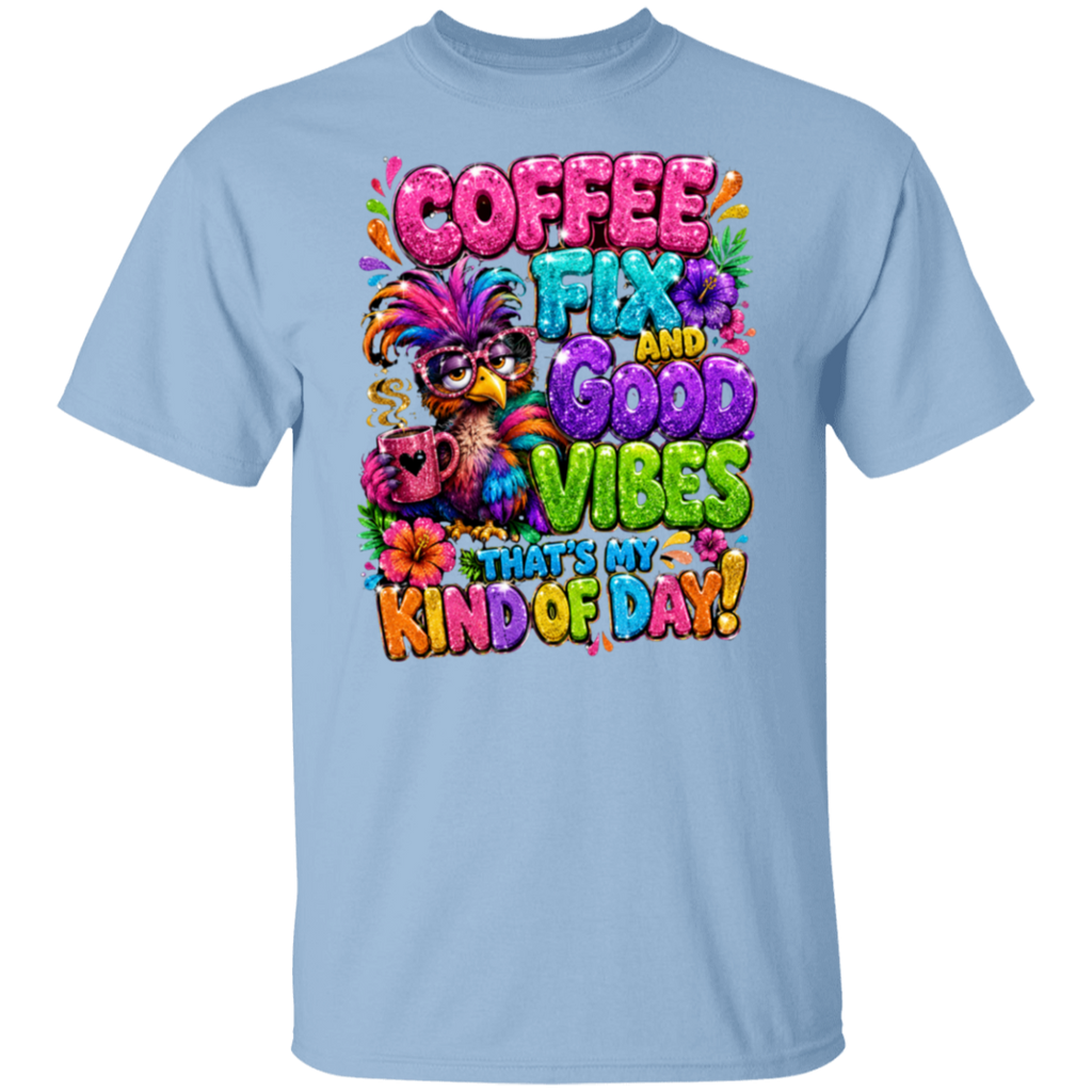 A light blue crewneck t-shirt featuring a colorful graphic print on the front. The graphic displays a bird wearing a feathered hat and sunglasses, holding a coffee mug, surrounded by the text 'COFFEE FIX AND GOOD VIBES THAT'S MY KIND OF DAY!' in vibrant, playful fonts.