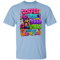 A light blue crewneck t-shirt featuring a colorful graphic print on the front. The graphic displays a bird wearing a feathered hat and sunglasses, holding a coffee mug, surrounded by the text 'COFFEE FIX AND GOOD VIBES THAT'S MY KIND OF DAY!' in vibrant, playful fonts.