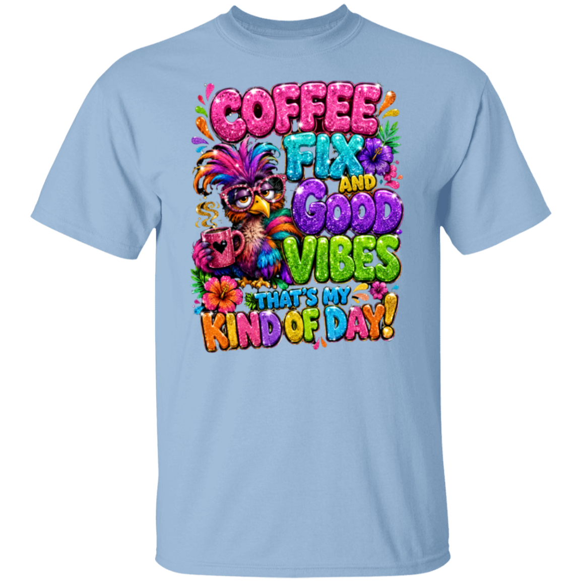 A light blue crewneck t-shirt featuring a colorful graphic print on the front. The graphic displays a bird wearing a feathered hat and sunglasses, holding a coffee mug, surrounded by the text 'COFFEE FIX AND GOOD VIBES THAT'S MY KIND OF DAY!' in vibrant, playful fonts.