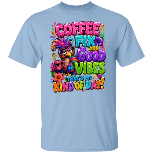 A light blue crewneck t-shirt featuring a colorful graphic print on the front. The graphic displays a bird wearing a feathered hat and sunglasses, holding a coffee mug, surrounded by the text 'COFFEE FIX AND GOOD VIBES THAT'S MY KIND OF DAY!' in vibrant, playful fonts.
