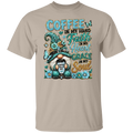 A sand crewneck t-shirt featuring a colorful graphic print of a gnome holding a coffee mug, surrounded by flowers and butterflies, with the text 'COFFEE IN MY HAND Faith IN My Heart GRACE IN My Soul'.