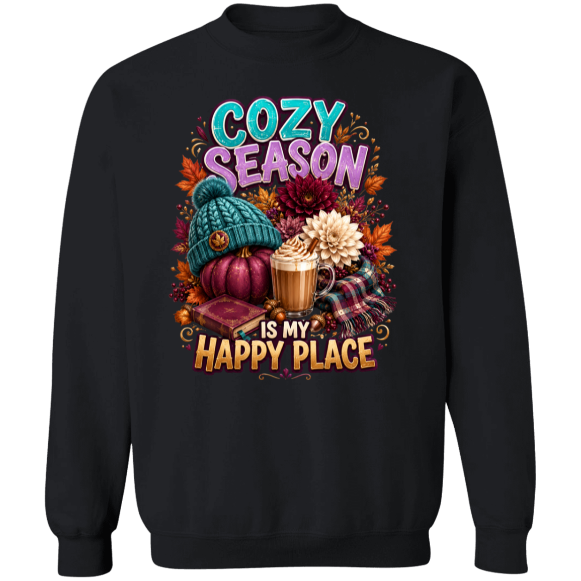 A black crewneck sweatshirt featuring a colorful autumn-themed graphic print with the text 'COZY SEASON IS MY HAPPY PLACE' and illustrations of a teal knit hat, a pumpkin, a hot cocoa mug, and fall leaves.