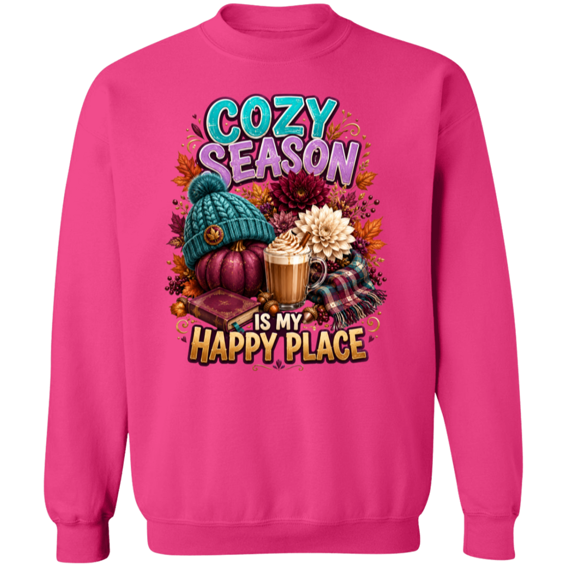 A heliconia color crewneck sweatshirt featuring a colorful graphic print on the front with the text 'COZY SEASON IS MY HAPPY PLACE' and autumn-themed illustrations including a teal knit hat, pumpkins, fall leaves, a mug of hot cocoa, and plaid fabric.
