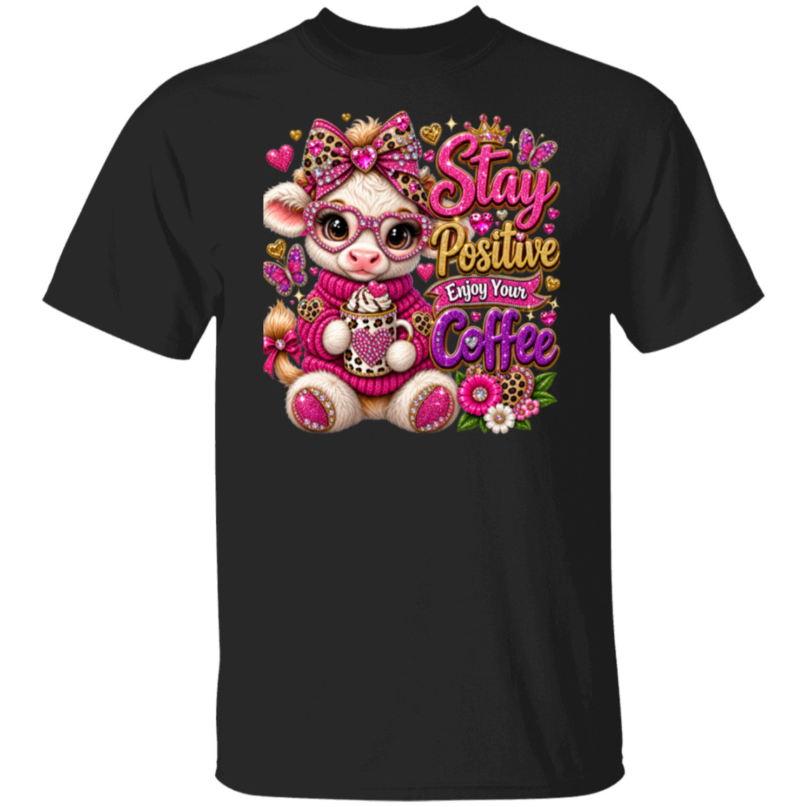A black short-sleeve crewneck t-shirt featuring a colorful graphic print of a cute cartoon cow wearing pink glasses and a pink sweater, surrounded by flowers, butterflies, and the text 'Stay Positive Enjoy Your Coffee'.