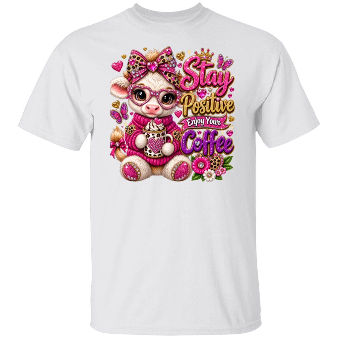 A white short-sleeve crewneck t-shirt featuring a colorful graphic print of a cute cartoon cow wearing pink glasses and a pink sweater, surrounded by flowers and butterflies, with the text 'Stay Positive Enjoy Your Coffee'.