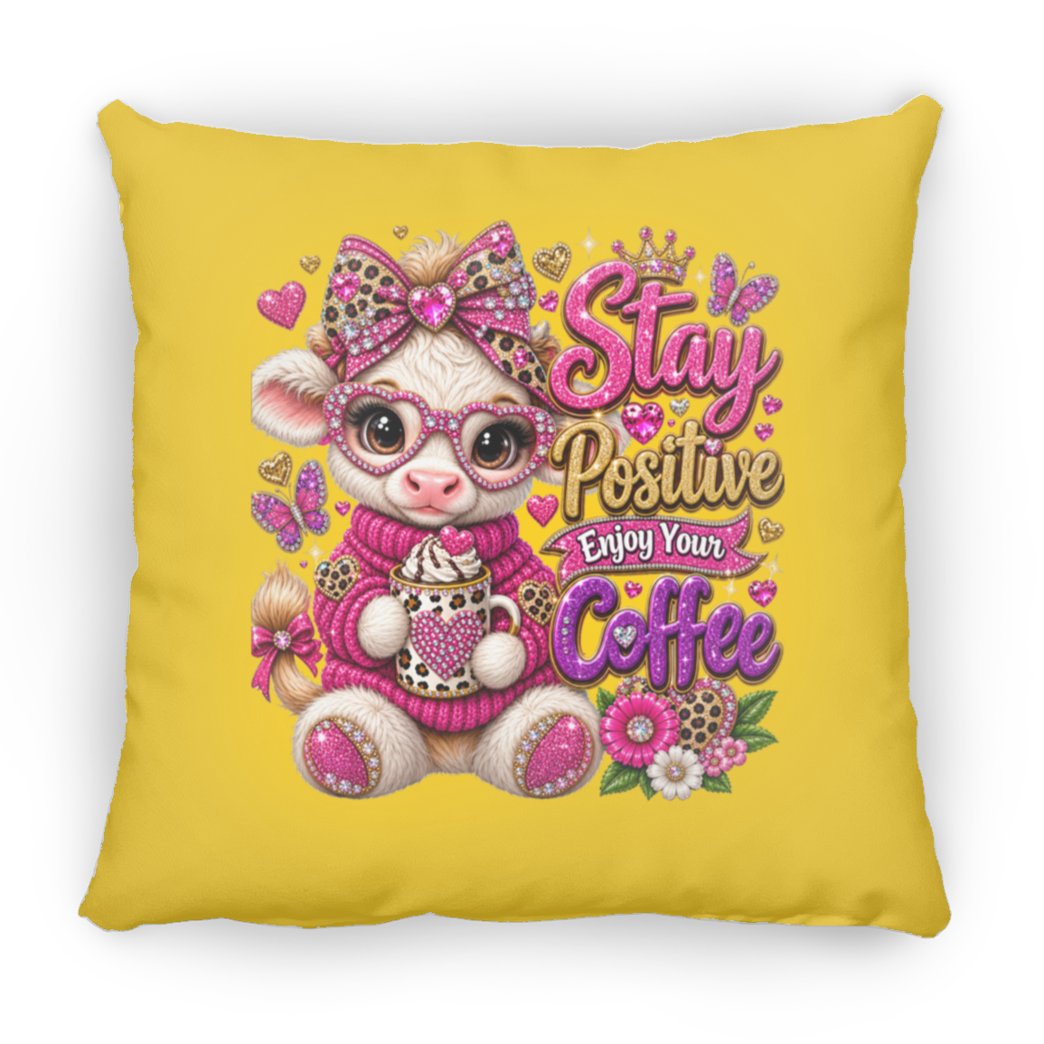 A square yellow throw pillow featuring a colorful graphic of a cute cartoon cow wearing pink leopard-print glasses and a pink bow, holding a coffee mug next to the text 'Stay Positive Enjoy Your Coffee' in pink and gold lettering.