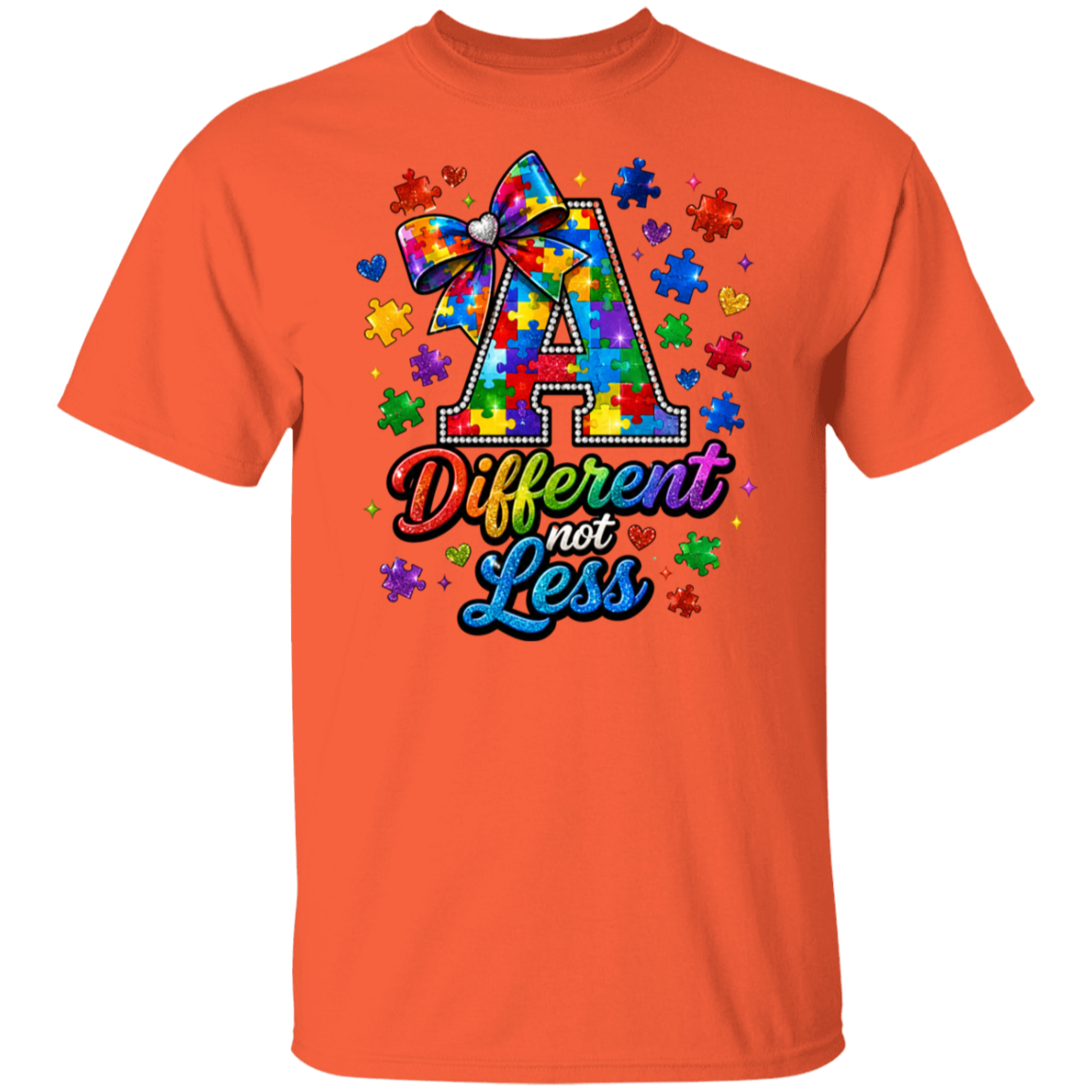 An orange short-sleeve crewneck t-shirt featuring a colorful graphic on the chest. The graphic displays a large letter 'A' filled with a tie-dye puzzle pattern and a matching bow, surrounded by puzzle pieces and hearts, with the text 'Different not Less' written below in a rainbow gradient font.