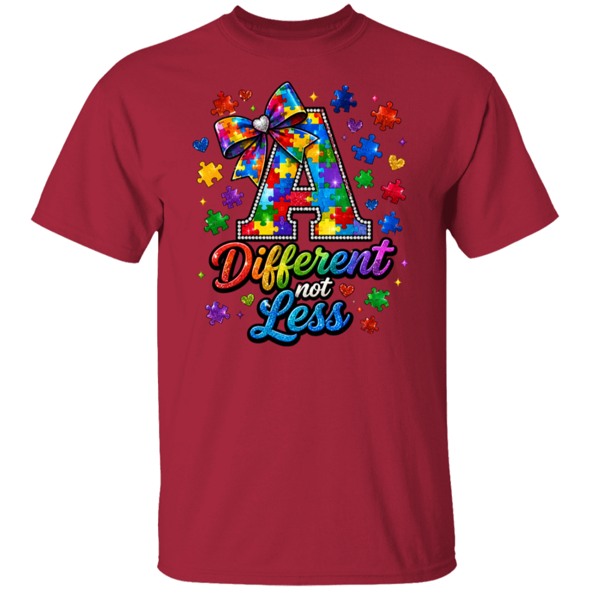 A cardinal short-sleeve crewneck t-shirt featuring a colorful graphic on the chest. The graphic displays a large letter 'A' filled with a tie-dye puzzle pattern and a matching bow, surrounded by puzzle pieces, hearts, and stars, with the text 'Different not Less' written below in a rainbow gradient font.