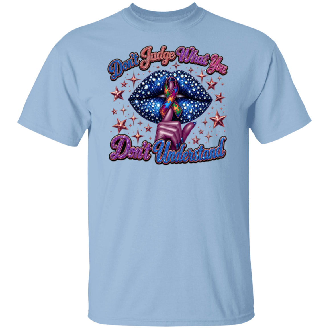 A light blue short-sleeve crewneck t-shirt featuring a graphic design on the front. The graphic shows a pink hand holding a blue starry lips-shaped object with a rainbow awareness ribbon inside, surrounded by red stars, with the text 'Don't Judge What You Don't Understand!' in pink and purple cursive.