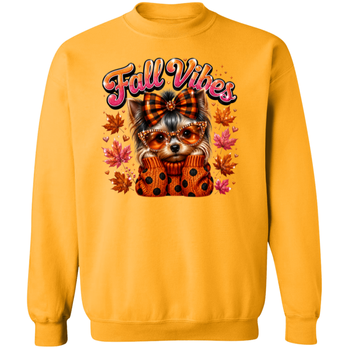 A gold color crewneck sweatshirt featuring a graphic of a small dog wearing an orange polka-dot sweater and sunglasses, surrounded by autumn leaves and the text 'Fall Vibes' in pink and orange.