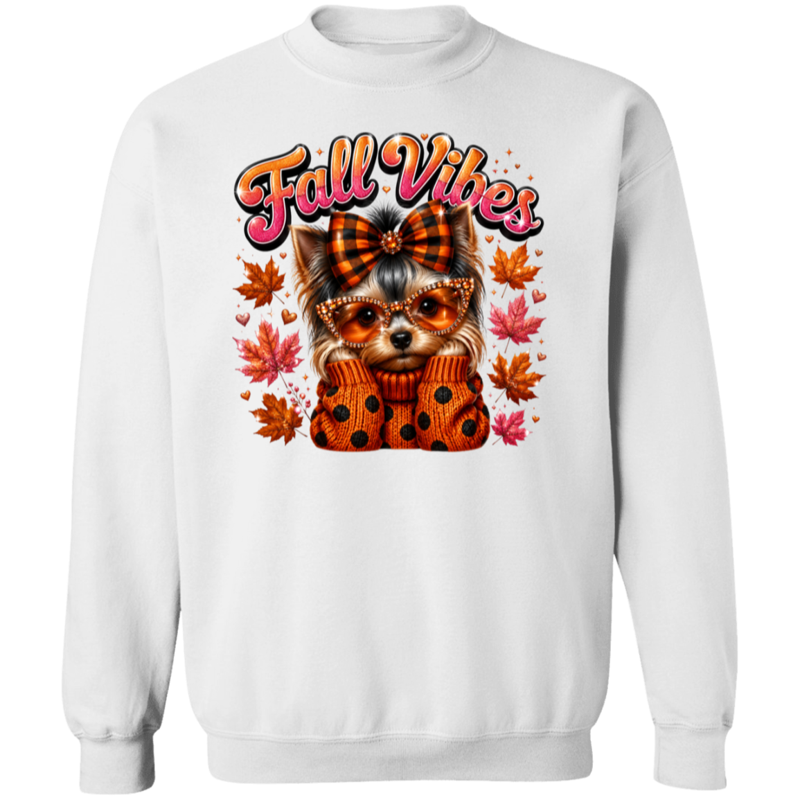 A white crewneck sweatshirt featuring a colorful graphic of a small dog wearing an orange plaid bow and polka-dot sweater, surrounded by autumn leaves, with the text 'Fall Vibes' in orange and pink.