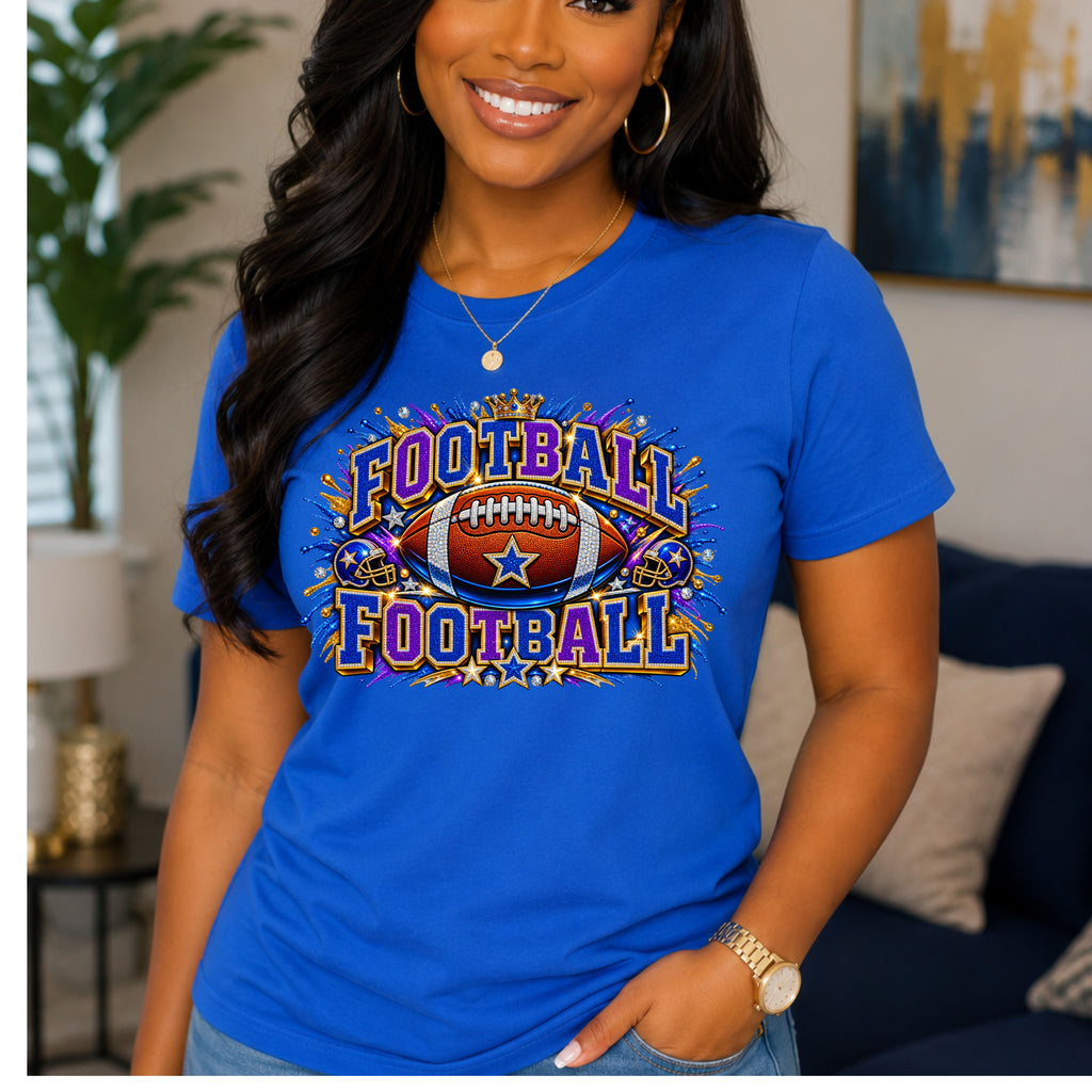 A woman wearing a bright blue graphic t-shirt with a 'Football Football' design featuring a football and stars, posed in a living room setting.