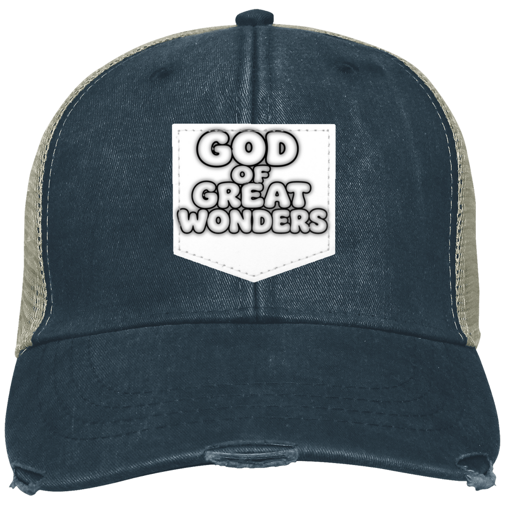 A distressed trucker hat with a dark  black color washed front panel and brim, beige mesh side/back panels, and a white front patch reading 'GOD OF GREAT WONDERS'.