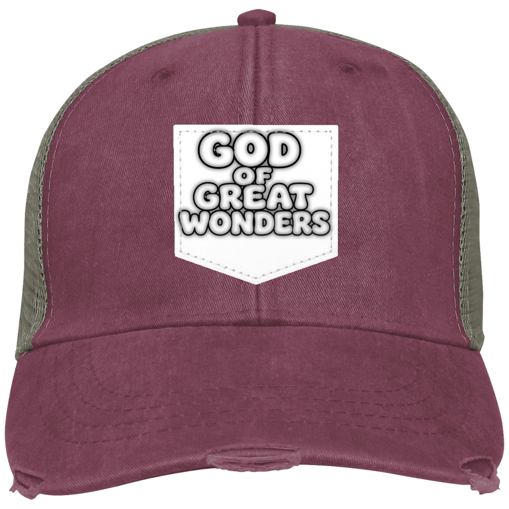 A distressed trucker-style baseball cap in washed khaki color with olive green mesh side panels and a white patch on the front that reads 'GOD OF GREAT WONDERS'.