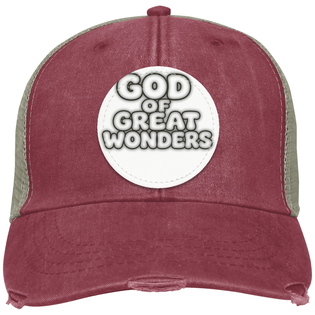 A distressed trucker hat in nautical red with sage green mesh side panels and a white circular patch on the front that reads 'GOD OF GREAT WONDERS'.
