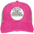 A distressed trucker hat in vibrant pink/tan color with a gray mesh back, featuring a circular white patch on the front that reads 'GOD OF GREAT WONDERS' in bold black and white lettering.