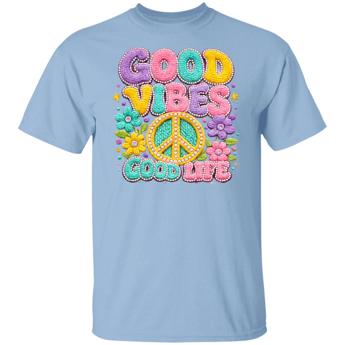 A light blue short-sleeve crewneck t-shirt featuring a colorful retro graphic on the chest with the text 'GOOD VIBES GOOD LIFE' in pastel bubble letters and a peace sign surrounded by flowers.