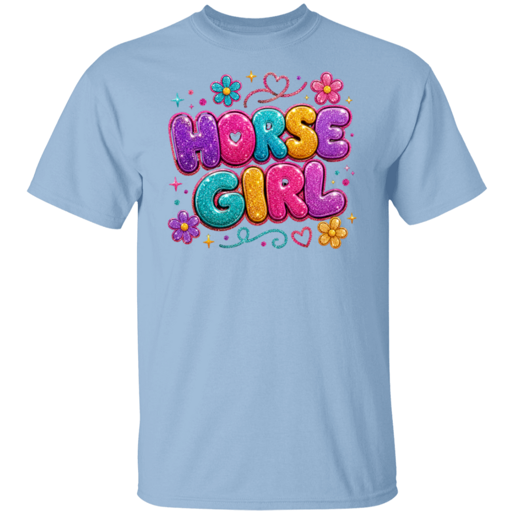 A light blue color short-sleeve crewneck t-shirt featuring a colorful graphic print on the chest that reads 'HORSE GIRL' in bubbly, glitter-textured letters with flowers and hearts.