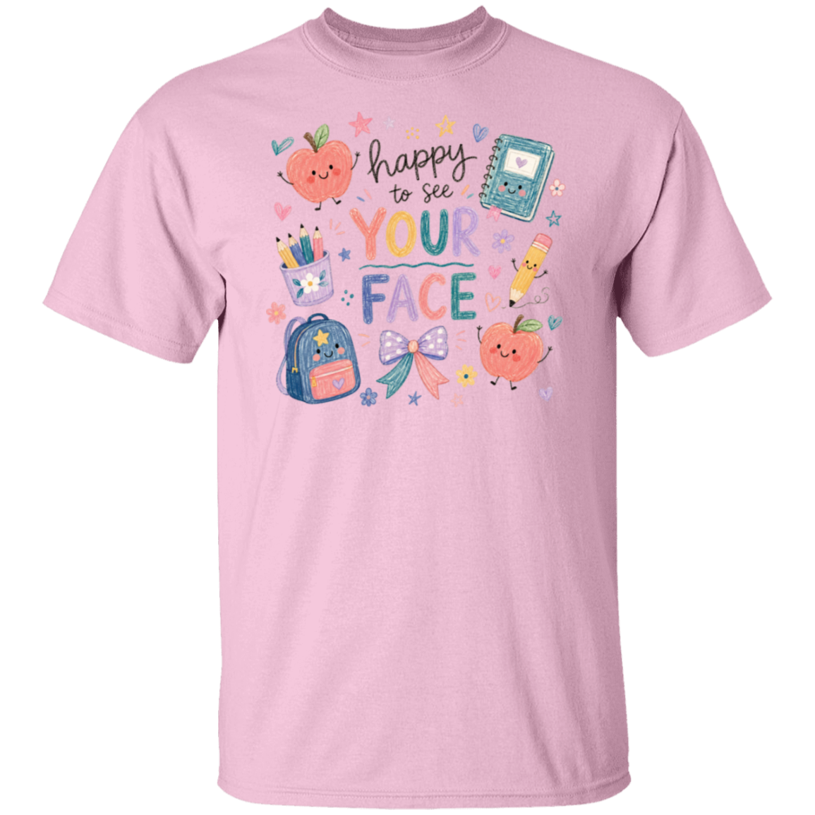A light pink short-sleeve crewneck t-shirt featuring a colorful back-to-school-themed graphic on the chest with cute illustrations of an apple, notebook, backpack, pencil, and the phrase 'happy to see YOUR FACE'.
