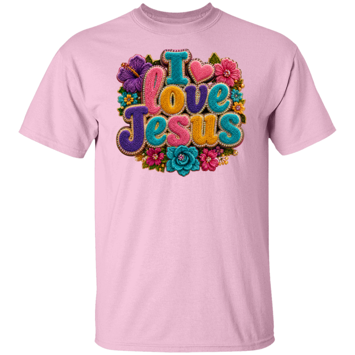 A light pink short-sleeve crewneck t-shirt featuring a colorful retro-style graphic on the chest that reads 'I love Jesus' in textured, 3D letters surrounded by flowers.