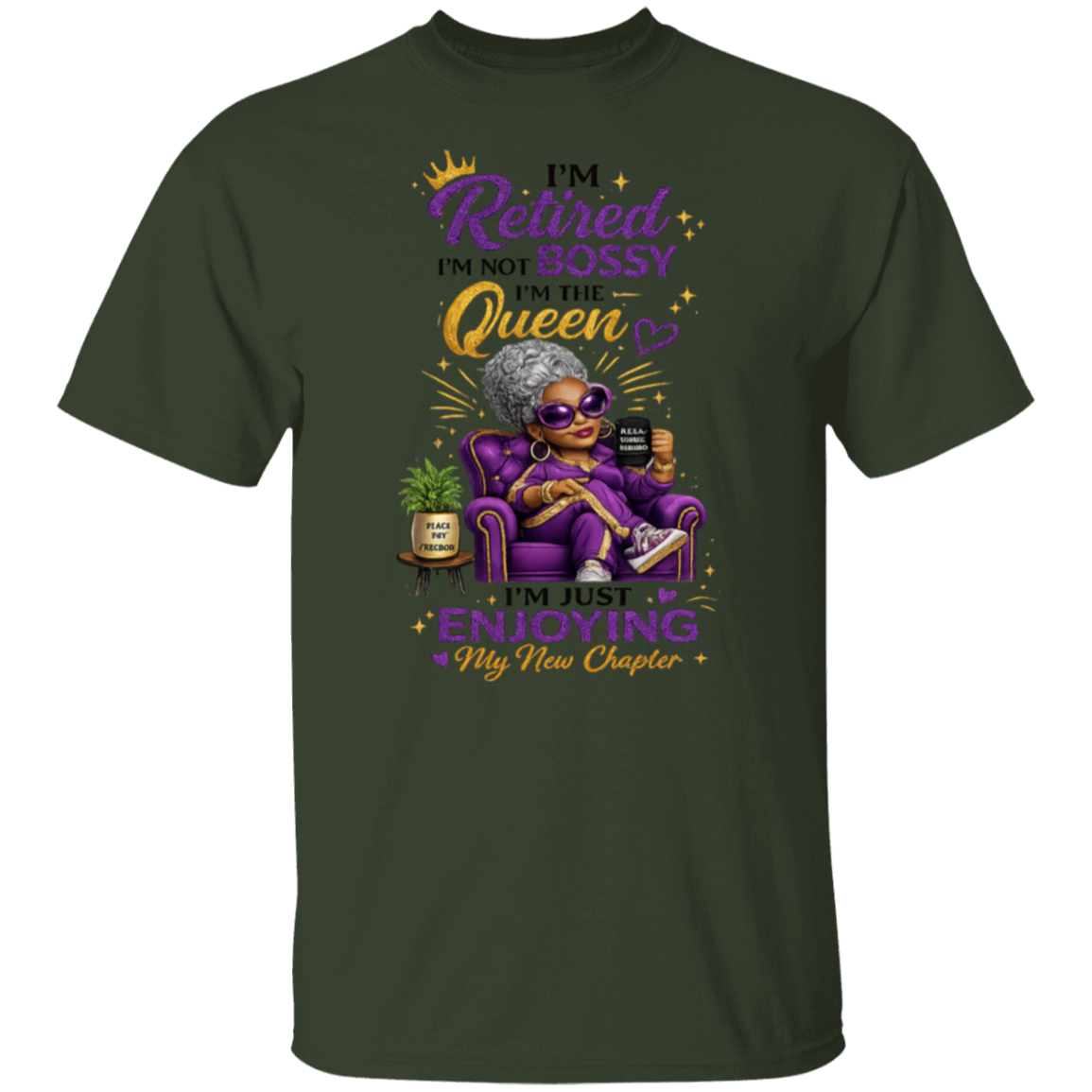 A dark forest green short-sleeve t-shirt with a colorful graphic of an elderly woman in a purple armchair, wearing sunglasses, holding a mug, and next to a small potted plant. The text reads 'I'm Retired I'm NOT Bossy I'm the Queen I'm just ENJOYING My New Chapter' in purple, yellow, and white lettering.