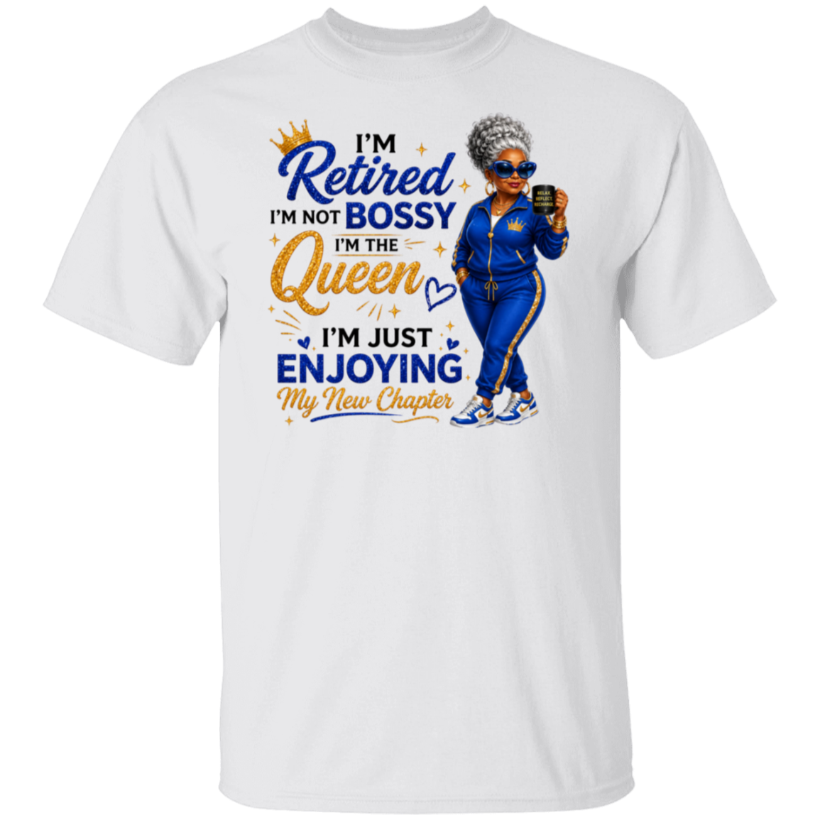 A white short-sleeve crewneck t-shirt featuring a colorful graphic print on the front. The graphic displays a cartoon illustration of a woman in a blue tracksuit holding a phone, next to the text 'I'm Retired I'm Not Bossy I'm The Queen I'm Just Enjoying My New Chapter' in blue and gold fonts.