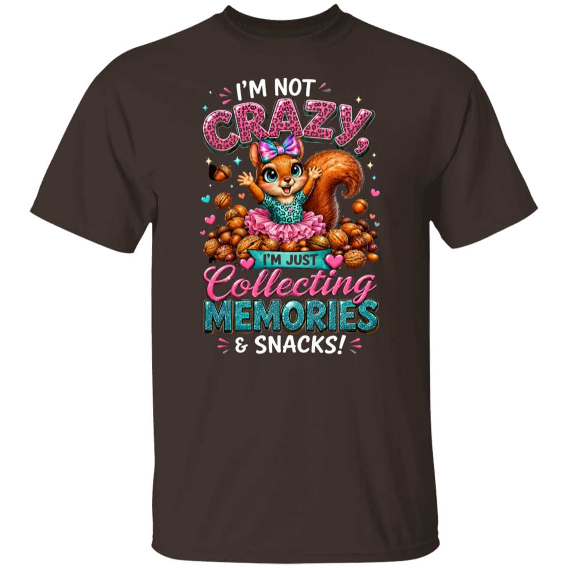 A dark chocolate color short-sleeve t-shirt with a colorful graphic of a cartoon squirrel wearing a pink tutu and holding a bag of chips, surrounded by peanuts, with the text 'I'M NOT CRAZY, I'M JUST Collecting MEMORIES & SNACKS!'.