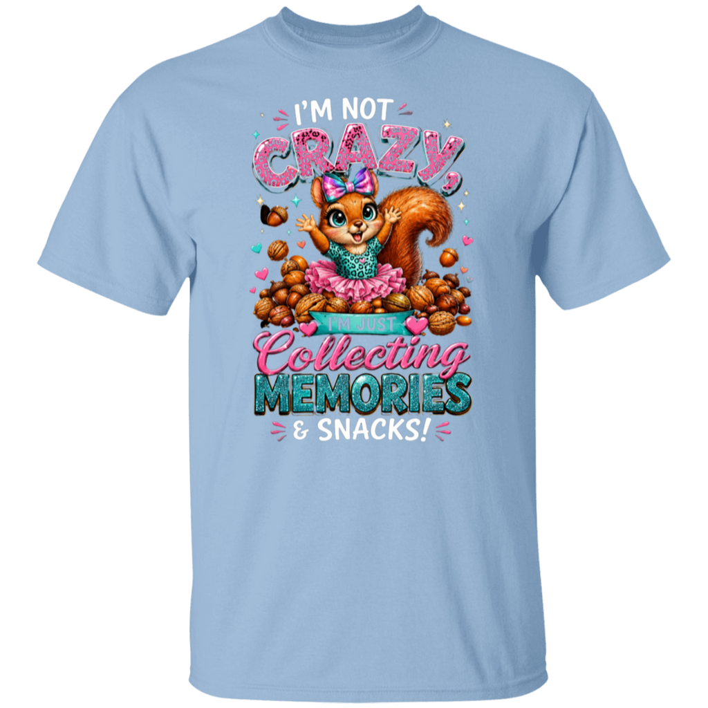 A light blue short-sleeve crewneck t-shirt featuring a colorful graphic of a cartoon squirrel surrounded by snacks, with the text 'I'M NOT CRAZY, Collecting MEMORIES & SNACKS!'.
