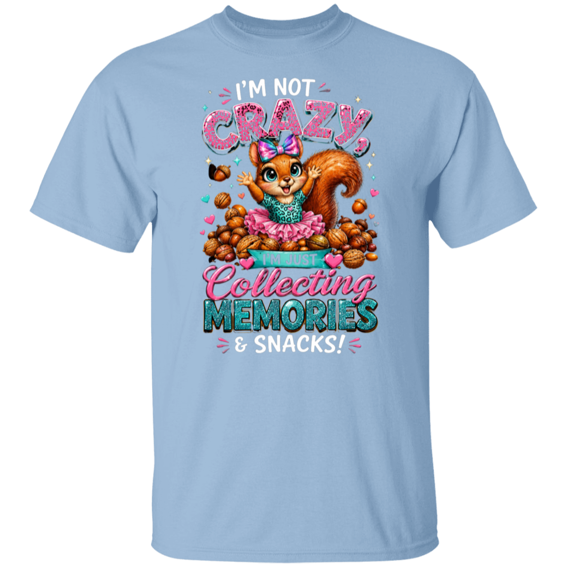 A light blue short-sleeve crewneck t-shirt featuring a colorful graphic of a cartoon squirrel surrounded by snacks, with the text 'I'M NOT CRAZY, Collecting MEMORIES & SNACKS!'.
