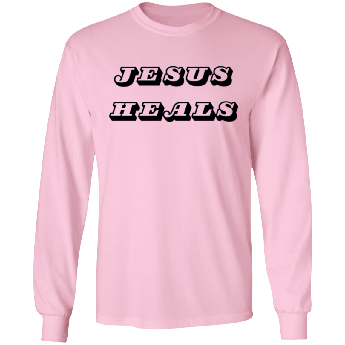 A light pink long-sleeve t-shirt with the words 'JESUS HEALS' printed across the chest in a black and white stylized font, shown against a plain white background.