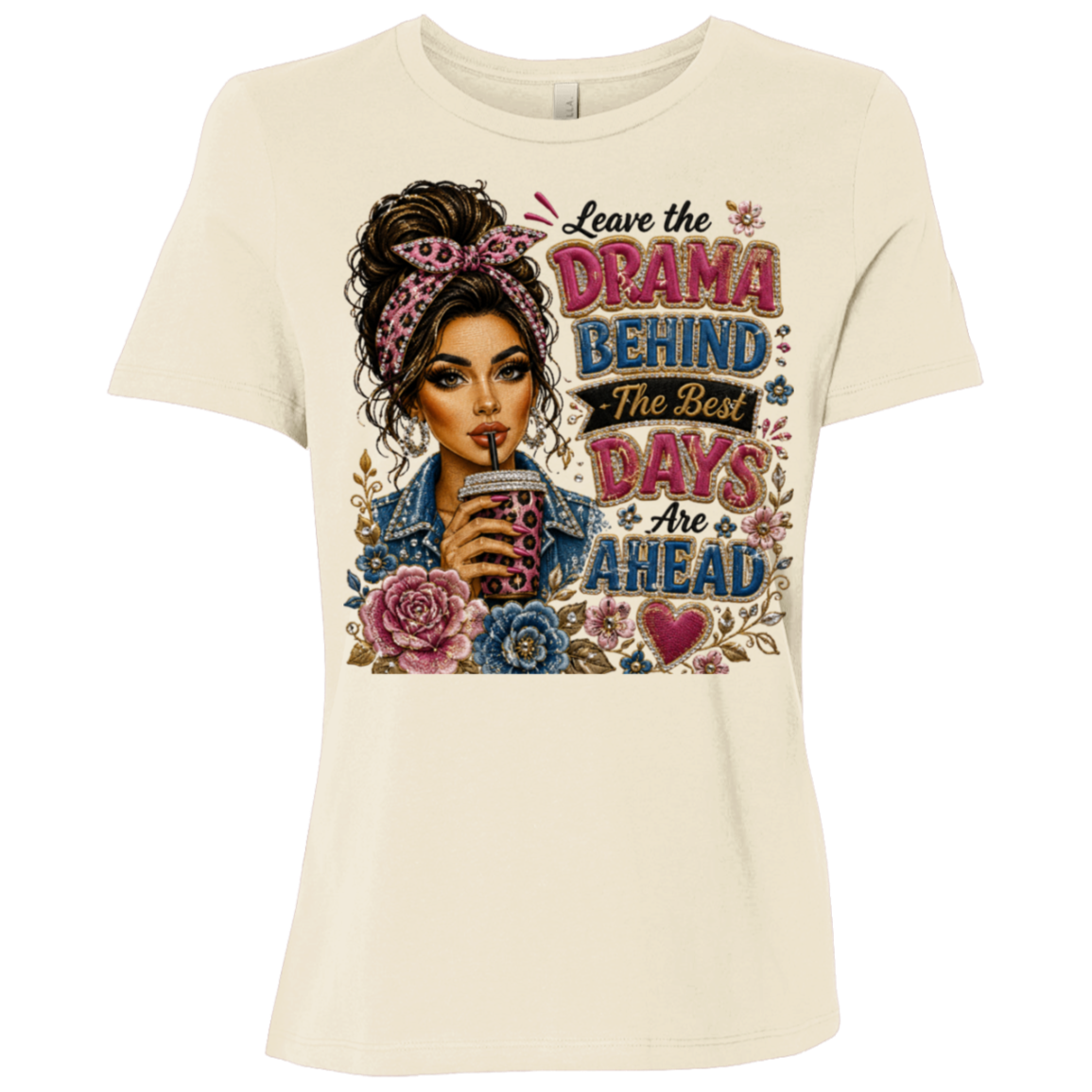 A natural color short-sleeve t-shirt with a colorful graphic print on the front. The graphic features an illustration of a woman with an updo hairstyle, holding a cup to her mouth, surrounded by flowers and the text 'Leave the DRAMA BEHIND The Best DAYS Are AHEAD'.
