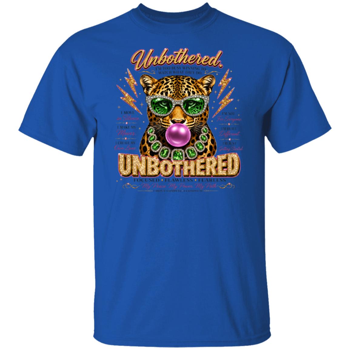A royal blue short-sleeve crewneck t-shirt featuring a colorful graphic print of a leopard wearing green sunglasses and a green beaded necklace, blowing a pink bubblegum bubble. The graphic includes the words 'Unbothered' and 'Unbothered' in stylized fonts, surrounded by motivational text.