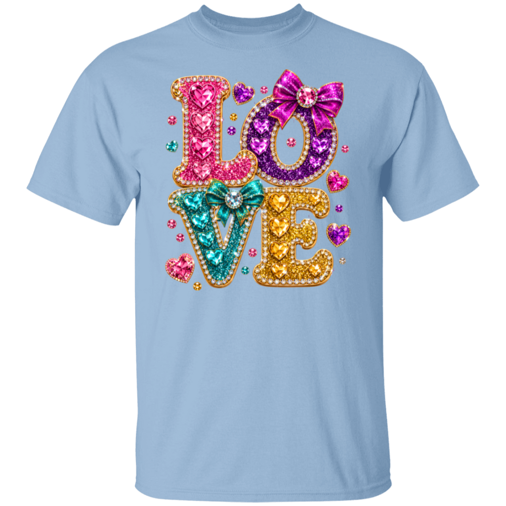 A light blue crewneck t-shirt featuring a large, colorful 'LOVE' graphic on the chest. The letters are filled with pink, purple, and teal sequins, outlined with gold rhinestones, and decorated with sequin bows and small heart details.