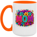 A white ceramic mug with a bright orange handle and interior rim, featuring a colorful floral graphic and the word 'MOM' in glittery pink, teal, and purple letters on the front.