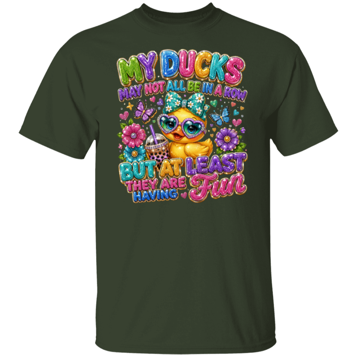A forest green short-sleeve t-shirt with a colorful graphic print on the front. The graphic features a cute cartoon duck wearing sunglasses and a bow tie, surrounded by flowers, butterflies, and the text 'MY DUCKS MAY NOT ALL BE A KIM OR BUT AT LEAST FUN THEY ARE HAVING'.
