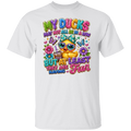 A white short-sleeve crewneck t-shirt featuring a colorful graphic print on the front. The graphic shows a cute cartoon duck wearing sunglasses and a party hat, surrounded by flowers, butterflies, and the text 'MY DUCKS MAY NOT ALL BE IN A ROW BUT AT LEAST THEY ARE HAVING Fun'.