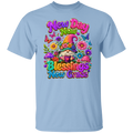 A light blue crewneck t-shirt featuring a colorful graphic print on the front with a gnome, flowers, butterflies, and the text 'New Day New Blessings New Grace'.
